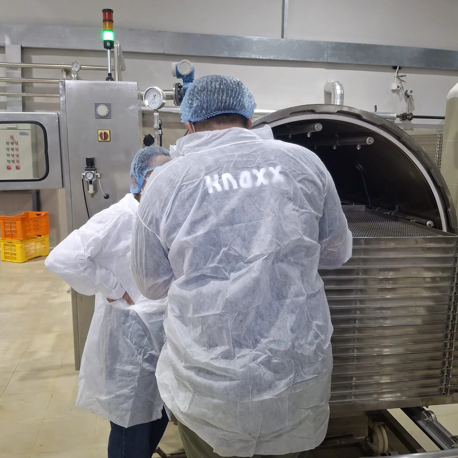 Knoxx food technologists inspecting trays loaded into a commercial retort vessel