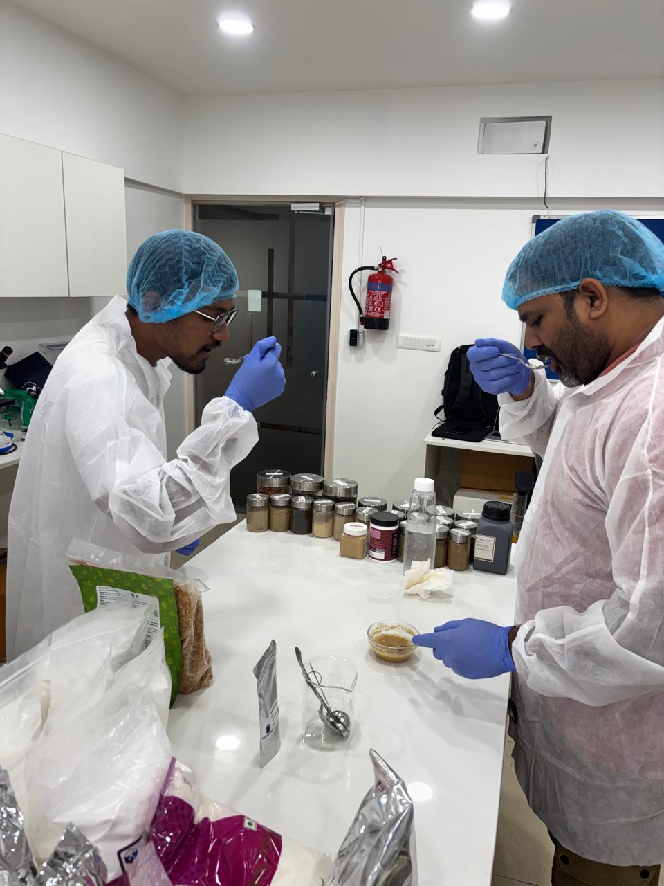 Team members evaluating development samples at the laboratory bench.