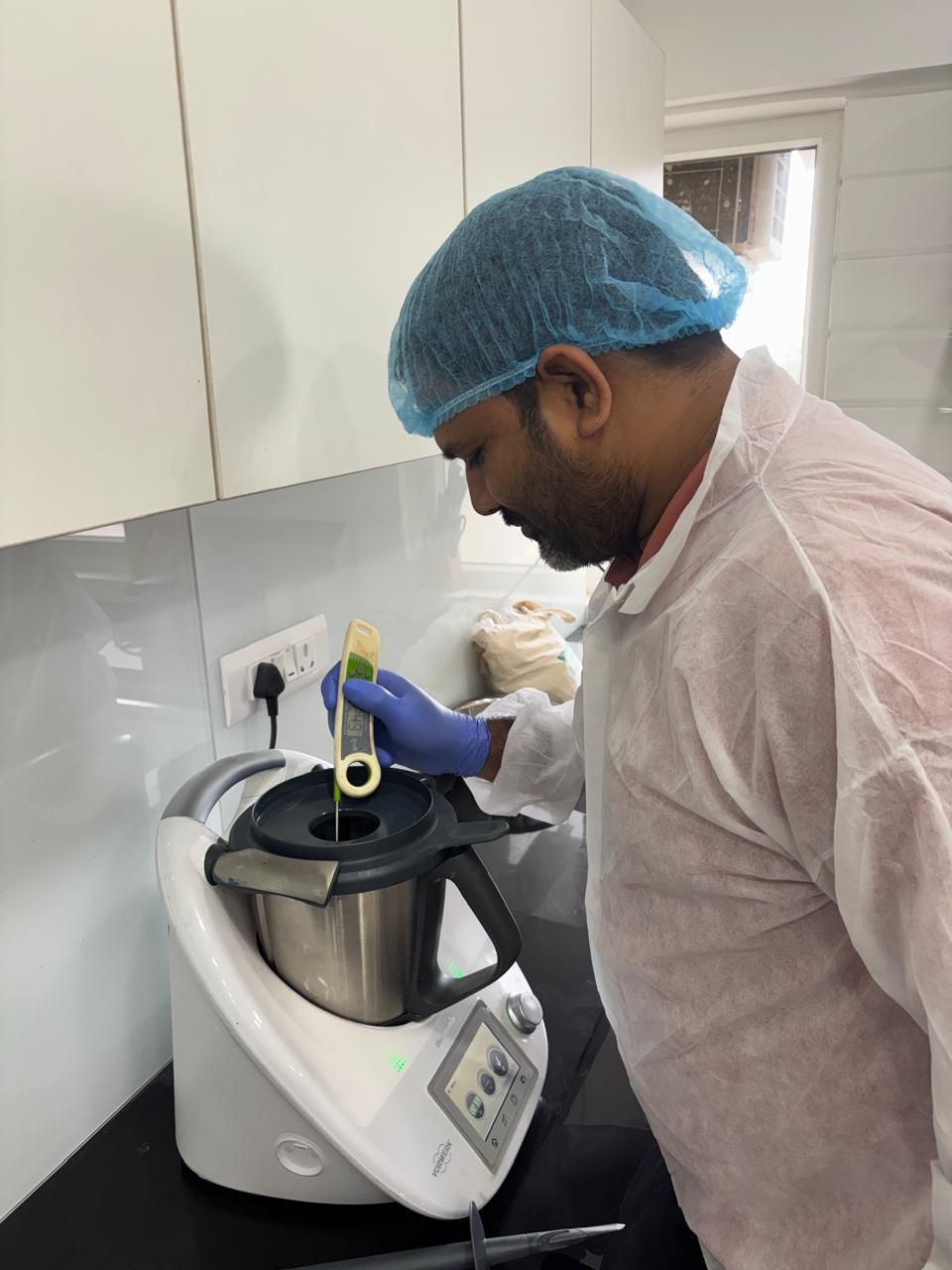 Food scientist checking the temperature of a prototype during process development.