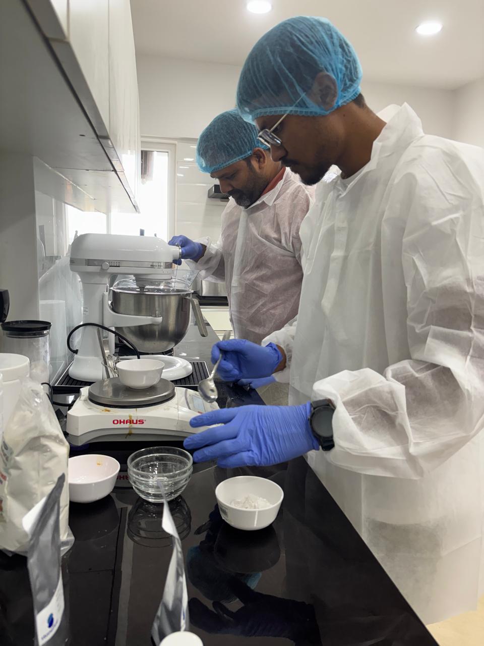 Food development team weighing and preparing ingredients in the laboratory.